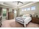 Bright main bedroom with decorative tray ceiling, large windows, carpeted floor, and an iron bed frame at 5042 Alston Dr, Lancaster, SC 29720