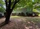 The backyard features mature trees and a back deck at 6007 Crosswood Ct, Charlotte, NC 28215