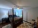Spacious bedroom with a ceiling fan, four-poster bed, neutral walls, and area rug at 6007 Crosswood Ct, Charlotte, NC 28215