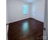 Simple bedroom with hardwood floors and window at 6007 Crosswood Ct, Charlotte, NC 28215