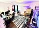 Spacious bedroom with a desk, guitars, and a vibrant rug at 6007 Crosswood Ct, Charlotte, NC 28215