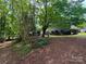 Cozy home with a fenced yard, lush trees, and beautiful landscaping at 6007 Crosswood Ct, Charlotte, NC 28215