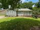 Quaint home featuring a well-kept lawn and a charming front porch at 6007 Crosswood Ct, Charlotte, NC 28215