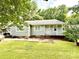 Charming single-story home featuring a cozy front porch, complemented by a well-maintained lawn at 6007 Crosswood Ct, Charlotte, NC 28215
