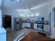Modern kitchen with stainless steel appliances, white cabinetry, tile flooring, and ample counter space at 6007 Crosswood Ct, Charlotte, NC 28215