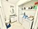 Laundry room with washer, dryer, granite-topped sink, and overhead cabinets at 6007 Crosswood Ct, Charlotte, NC 28215