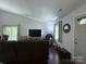 Bright living room with hardwood floors, large window, and comfortable seating arrangement at 6007 Crosswood Ct, Charlotte, NC 28215