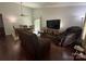 Open-concept living room with wood floors, ceiling fan and comfortable seating and dining area at 6007 Crosswood Ct, Charlotte, NC 28215