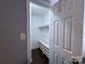 Bright walk-in closet featuring built-in shelving and a hanging rod at 6007 Crosswood Ct, Charlotte, NC 28215