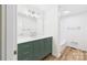 Bathroom featuring green vanity with quartz countertop, modern fixtures and wood-look flooring at 61 23Rd Nw St, Hickory, NC 28601