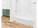 Bright white bathroom showcasing a modern bathtub and walk in shower with modern hardware and wood-look flooring at 61 23Rd Nw St, Hickory, NC 28601