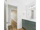 Bathroom featuring green vanity with quartz countertop, modern fixtures and wood-look flooring at 61 23Rd Nw St, Hickory, NC 28601