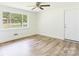 A bright bedroom with a large window, wood-look flooring and neutral paint at 61 23Rd Nw St, Hickory, NC 28601