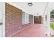 Spacious covered side porch with brick flooring and ample natural light at 61 23Rd Nw St, Hickory, NC 28601