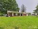 Charming brick home with a covered porch, attached garage, and green lawn at 61 23Rd Nw St, Hickory, NC 28601