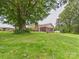 Brick home with a spacious yard, mature trees, and a welcoming front porch at 61 23Rd Nw St, Hickory, NC 28601