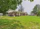 Quaint brick home with a classic covered porch and well-maintained front yard at 61 23Rd Nw St, Hickory, NC 28601