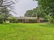 Charming brick ranch-style home with a lush lawn and mature trees offering serene curb appeal at 61 23Rd Nw St, Hickory, NC 28601