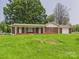 Brick home with covered porch, multiple entrances, and large front lawn at 61 23Rd Nw St, Hickory, NC 28601
