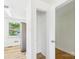 Hallway featuring an open closet with wooden floors and white walls at 61 23Rd Nw St, Hickory, NC 28601