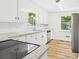 Bright kitchen with white cabinets, granite countertops, stainless steel appliances, and updated fixtures at 61 23Rd Nw St, Hickory, NC 28601