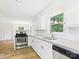 Bright kitchen with new appliances and countertops, open to dining area with outside views at 61 23Rd Nw St, Hickory, NC 28601