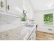 Updated kitchen with granite countertops, backsplash, stainless steel faucet, and natural light at 61 23Rd Nw St, Hickory, NC 28601