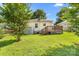 Backyard featuring mature tree and wooden deck at 611 Church St, Belmont, NC 28012