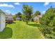 Grassy backyard with mature trees and storage shed at 611 Church St, Belmont, NC 28012