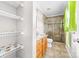 Bathroom with a granite-topped vanity, glass shower, and open storage at 611 Church St, Belmont, NC 28012