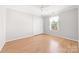 A bright bedroom with hardwood floors, a ceiling fan and a closet at 611 Church St, Belmont, NC 28012