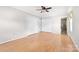 A bright bedroom with hardwood floors, a ceiling fan, and a closet at 611 Church St, Belmont, NC 28012
