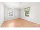 Bedroom with two windows with valances, hardwood floors, and a closet at 611 Church St, Belmont, NC 28012