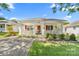 Inviting single-story home boasting a charming front porch, complemented by lush greenery and a well-maintained lawn at 611 Church St, Belmont, NC 28012