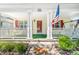 Close up view of a cozy front porch featuring a cheerful welcome mat and an American flag at 611 Church St, Belmont, NC 28012
