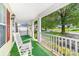 Relaxing front porch view of the street with a white rocking chair at 611 Church St, Belmont, NC 28012