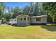 A charming home featuring a backyard with well-maintained lawn and mature trees at 7011 S Providence Rd, Waxhaw, NC 28173