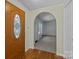 Inviting entryway with a decorative wooden front door and an archway leading to the living area at 7011 S Providence Rd, Waxhaw, NC 28173