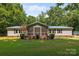 Charming single-story home with a screened-in porch and well-maintained front lawn at 7011 S Providence Rd, Waxhaw, NC 28173