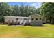 Charming single-story home with a metal roof, vinyl siding, and a lovely deck entrance at 7011 S Providence Rd, Waxhaw, NC 28173