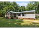 Home features a screened-in porch with a well-manicured lawn, offering a comfortable outdoor living space at 7011 S Providence Rd, Waxhaw, NC 28173