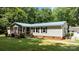 Charming single-story home with a blue metal roof, screened porch, and neatly manicured lawn at 7011 S Providence Rd, Waxhaw, NC 28173