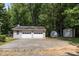 Detached two car garage with long driveway and outbuilding in wooded backyard at 7011 S Providence Rd, Waxhaw, NC 28173