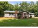 Property featuring a screened-in porch with a well-maintained yard and mature trees providing shade at 7011 S Providence Rd, Waxhaw, NC 28173