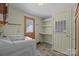 This laundry room has ample counter space, white cabinets, a wooden door, and a side-by-side washer and dryer at 7011 S Providence Rd, Waxhaw, NC 28173