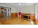 The space features a wood paneled accent wall, hardwood floors and views into the kitchen and another room beyond at 7011 S Providence Rd, Waxhaw, NC 28173
