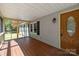 Relaxing front porch with wood flooring, traditional door and screened-in area at 7011 S Providence Rd, Waxhaw, NC 28173