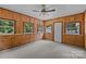 Spacious sunroom with wood-paneled walls, multiple windows providing plenty of natural light at 7011 S Providence Rd, Waxhaw, NC 28173