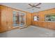 Cozy sunroom with wood-paneled walls, carpet, and sliding glass doors leading to the outside at 7011 S Providence Rd, Waxhaw, NC 28173