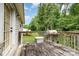 The back deck features weathered wood, a grill, and overlooks a lush green lawn and wooded area, creating a relaxing outdoor space at 704 Willow Rd, Salisbury, NC 28147